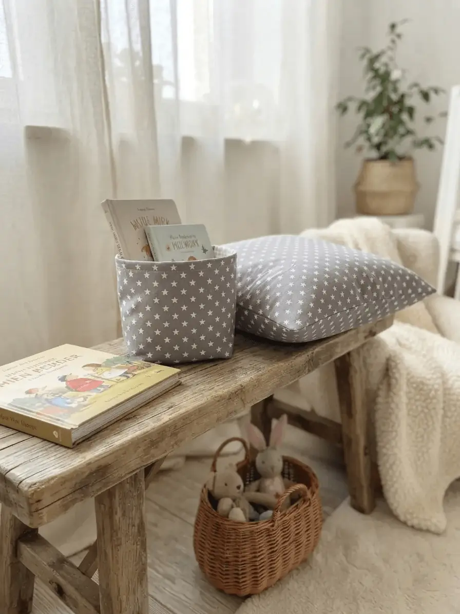 Helle, detailreiche Nahaufnahme eines Baumwoll-Webware-Stoffes mit einem kleinen, wiederkehrenden weißen Sternenmuster auf hellgrauem Grund. Perfekt für DIY-Nähprojekte und Kinderzimmer-Dekoration.