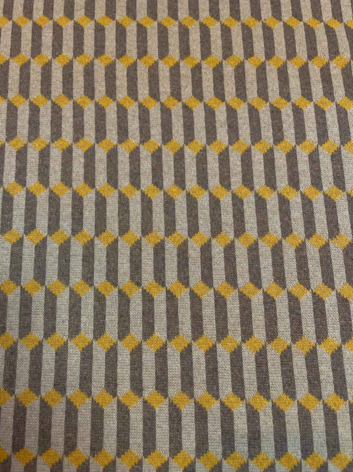 Hochwertiger Bio-Jacquard-Strickstoff mit einem geometrischen Allover-Muster. Das Design zeigt senfgelbe Rauten auf einem fein gestreiften Hintergrund in Grau, Beige und Anthrazit. Durch die spezielle Stricktechnik entsteht eine leichte 3D-Struktur. Ein b