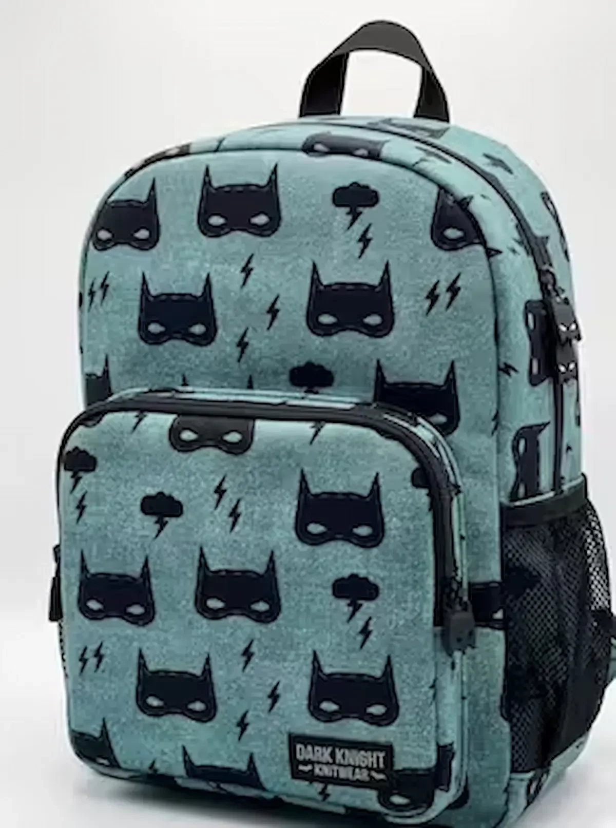 Robuster Baumwollstoff als Webware Meterware in Blaugrau mit schwarzen Superhelden-Masken und Blitzen, verarbeitet als fertiger Kinderrucksack vor weißem Hintergrund.