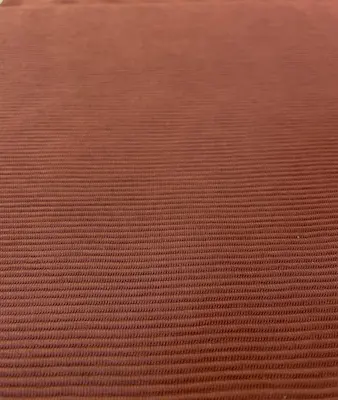 Nahaufnahme eines rostbraunen Ottoman-Jersey-Stoffs mit einer feinen, horizontalen Rippenstruktur.