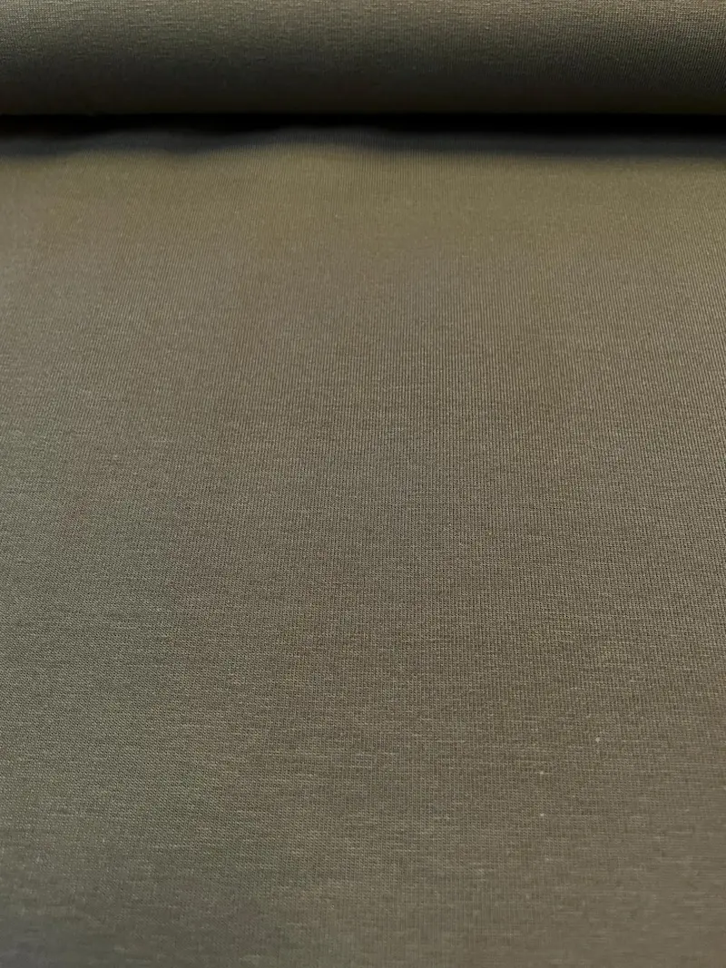 Nahaufnahme eines glatten, olivfarbenen Jersey-Stoffs (Schlamm), blickdichte Baumwoll-Meterware für Bekleidung.