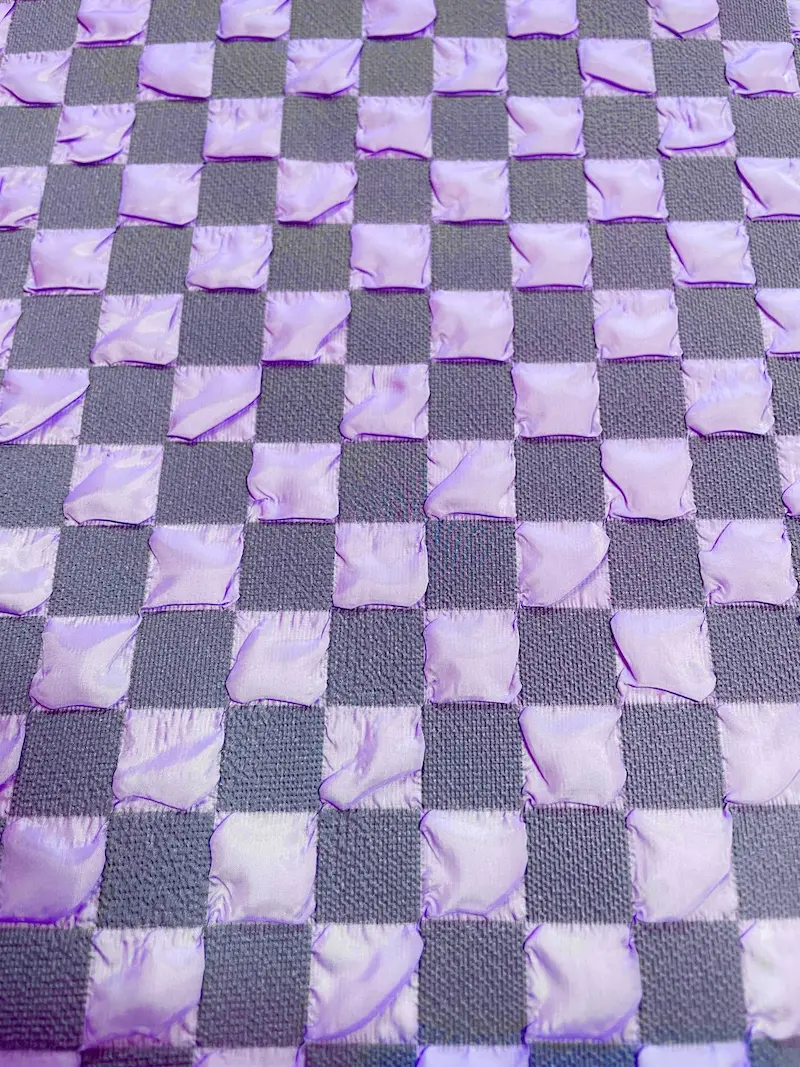 Strapazierfähiger Taschenstoff in Flieder-Lila mit plastischem 3D-Schachbrettmuster, ideal für moderne Rucksäcke, Tote Bags und Kosmetiktaschen.