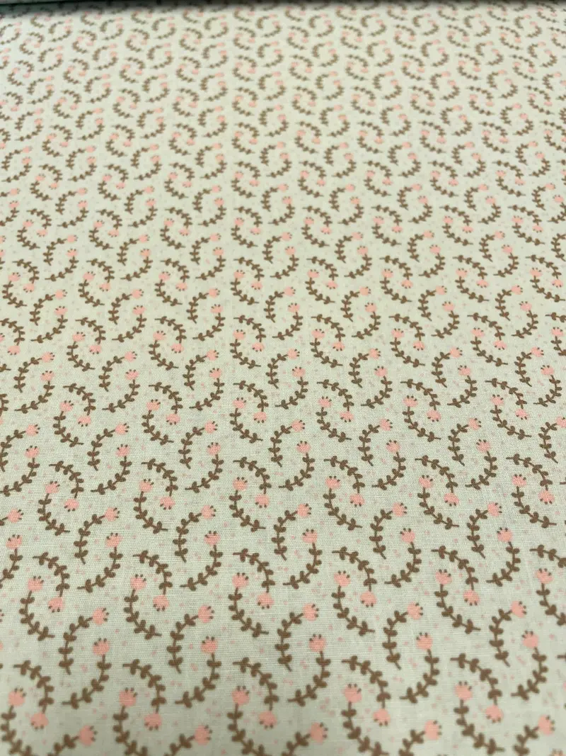 Hochwertiger Baumwollstoff als Meterware in hellem Mintgrün mit einem feinen, botanischen Muster aus zarten Zweigen und Blättern.