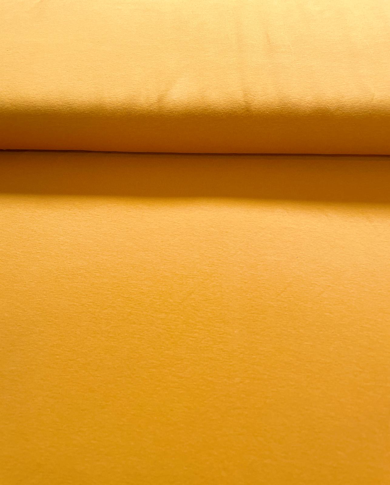 Glatter Baumwoll-Jersey in einem warmen, gedeckten Sonnengelb. Hochwertige 200g Meterware für Kleidung.