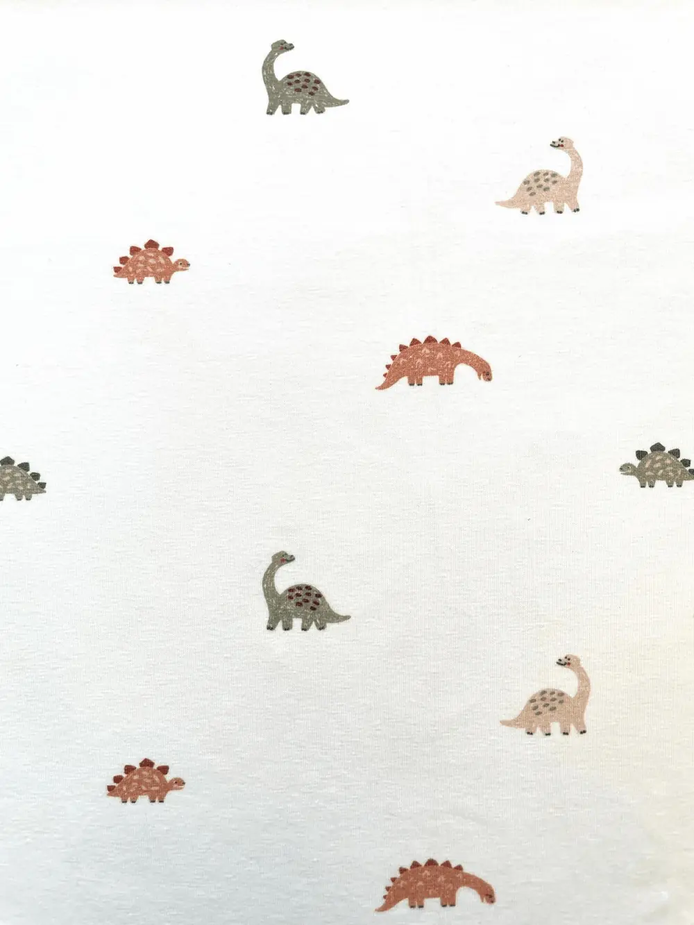 Baumwolljersey: Kleine Dinos auf Creme