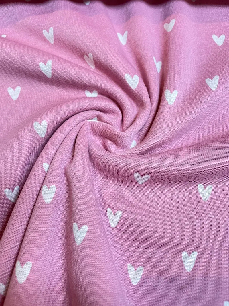 Dicker Alpenfleece in Rosa meliert mit weißen Herzen; Doubleface-Stoff mit extrem weicher Innenseite, perfekt für Hoodies, Decken und Winterjacken.
