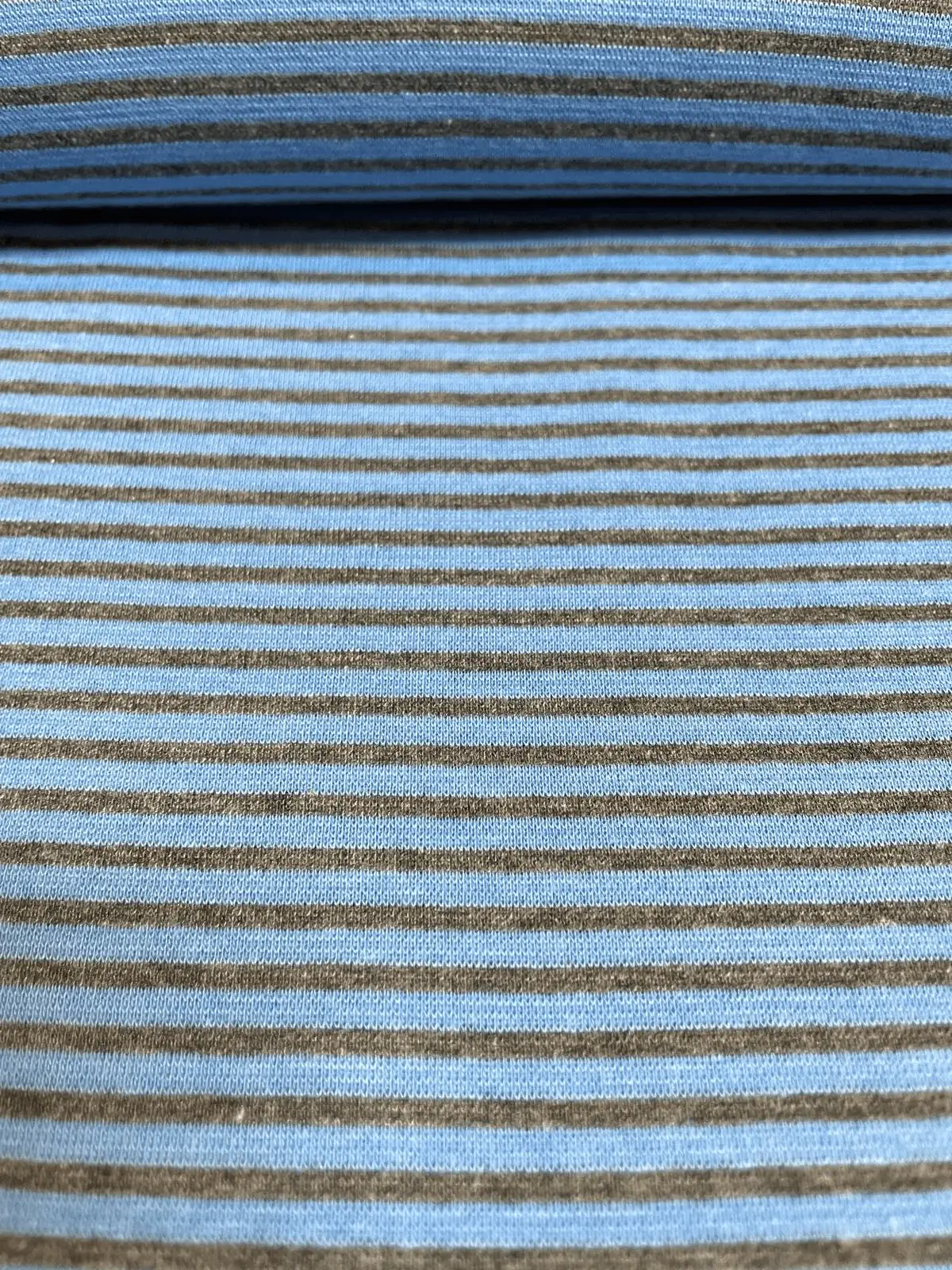 Gestreifter Bündchenstoff in Mittelblau und Dunkelgrau als elastische Schlauchware (Meterware) für Pulloverbündchen und sportliche Streetwear.