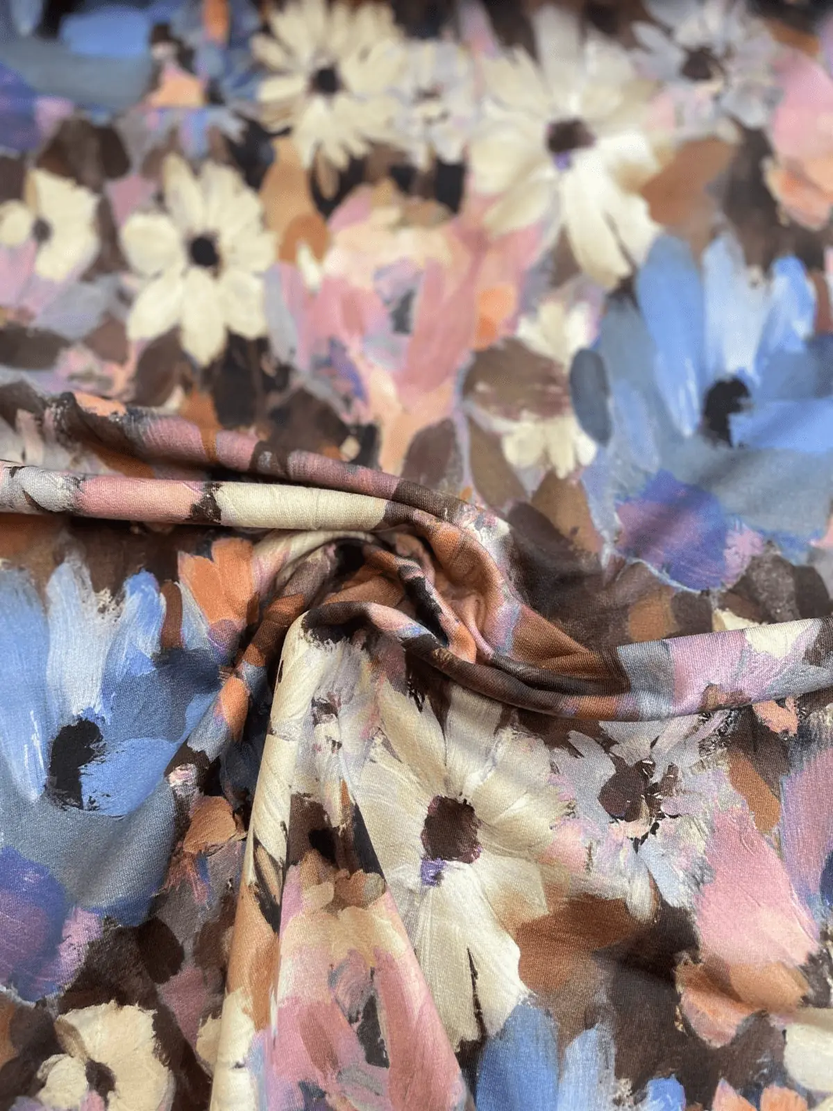 Drapierter French Terry Stoff als Meterware mit einem malerischen, abstrakten Blumen-Print im Pinselstrich-Stil in Blau, Beige und Rosa.