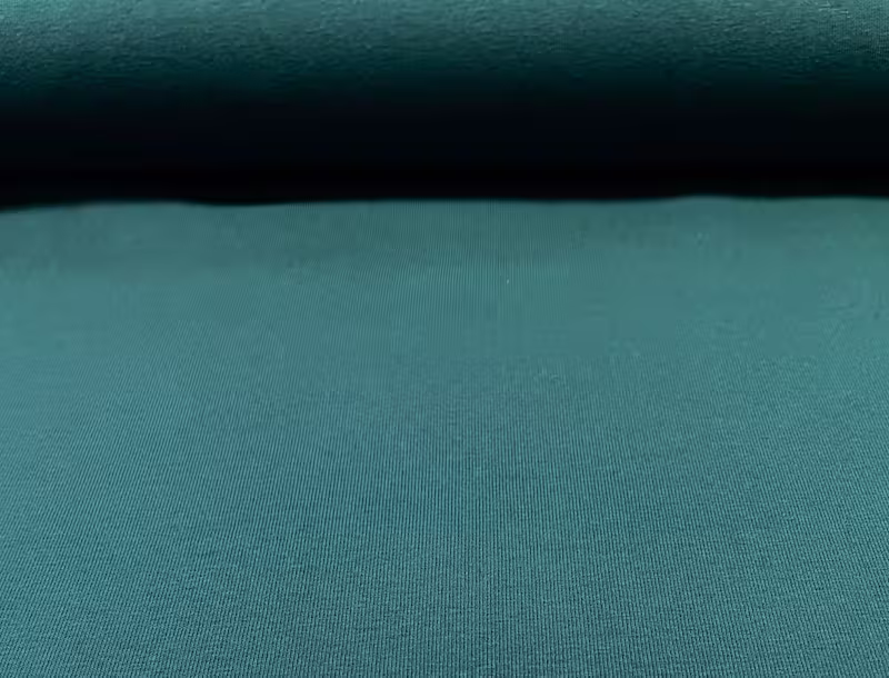 Nahaufnahme eines petrolgrünen Baumwolljerseys mit feiner Maschenstruktur, 92% Baumwolle und 8% Elasthan.