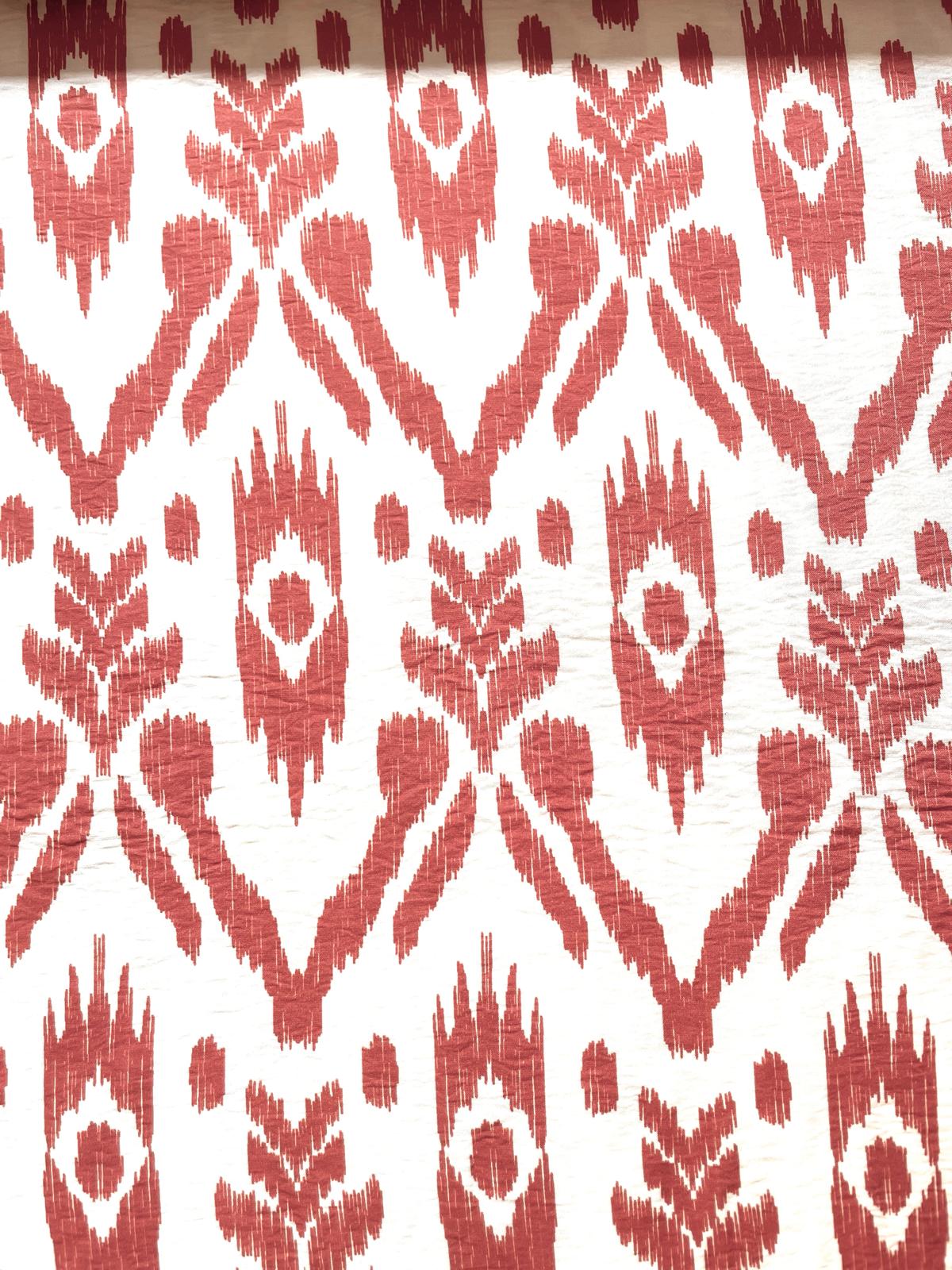 Leichter Viskose-Polyamid Stoff mit Knitteroptik und rostrot-weißem Ikat-Print.