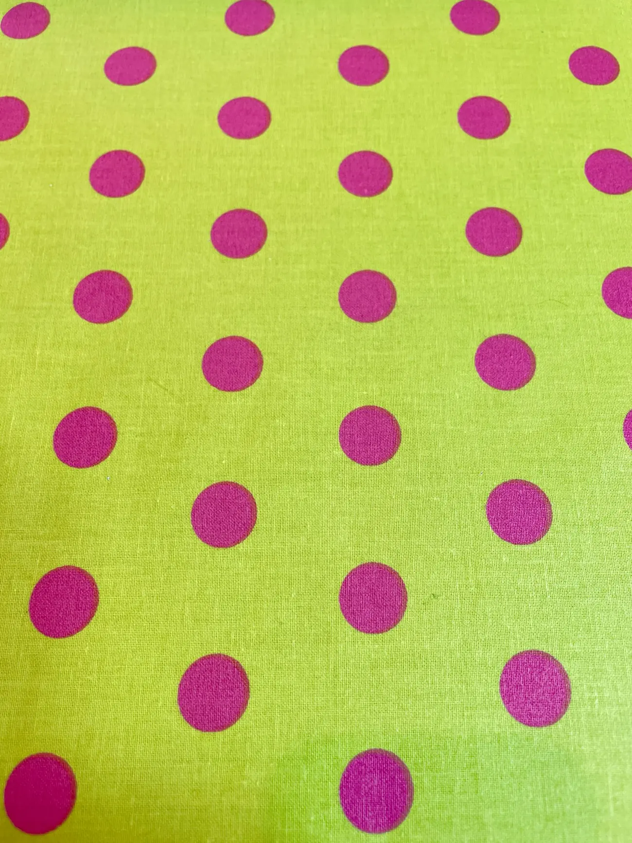Beschichtete Baumwolle in Lindgrün mit pinken Punkten – wasserabweisender Stoff für Tischdecken und Taschen.