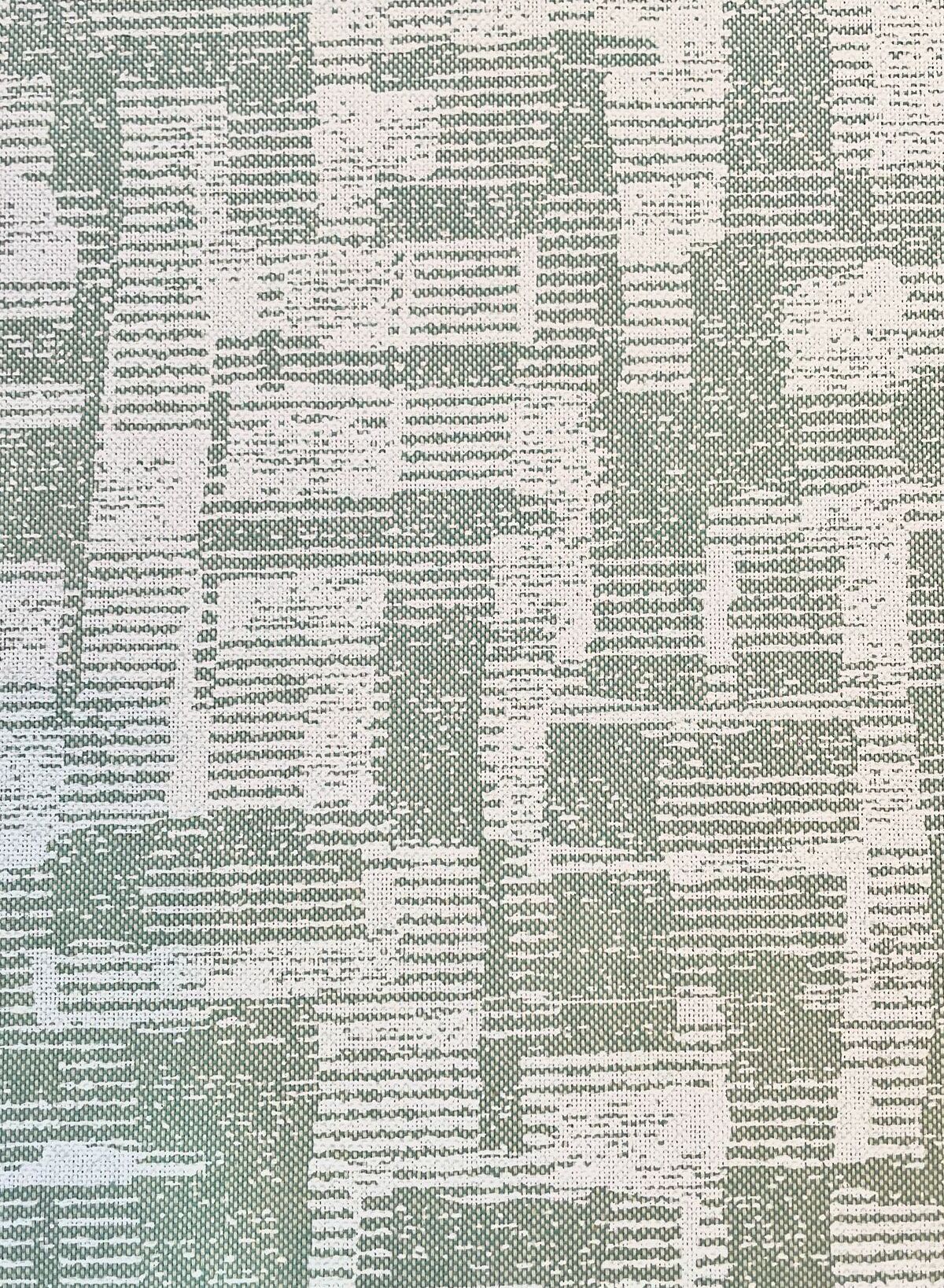 Nahaufnahme eines modernen Dekostoffs mit abstrakter, grafischer Webstruktur in Hellgrün und Weiß